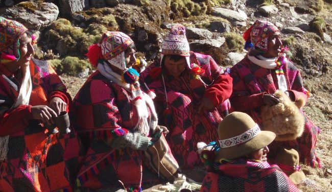 Q’ero elders in the high Andes, adorned in vibrant, hand-woven textiles rich with ancestral symbolism—guardians of a lineage deeply rooted in Inca heritage and Andean spiritual traditions.
